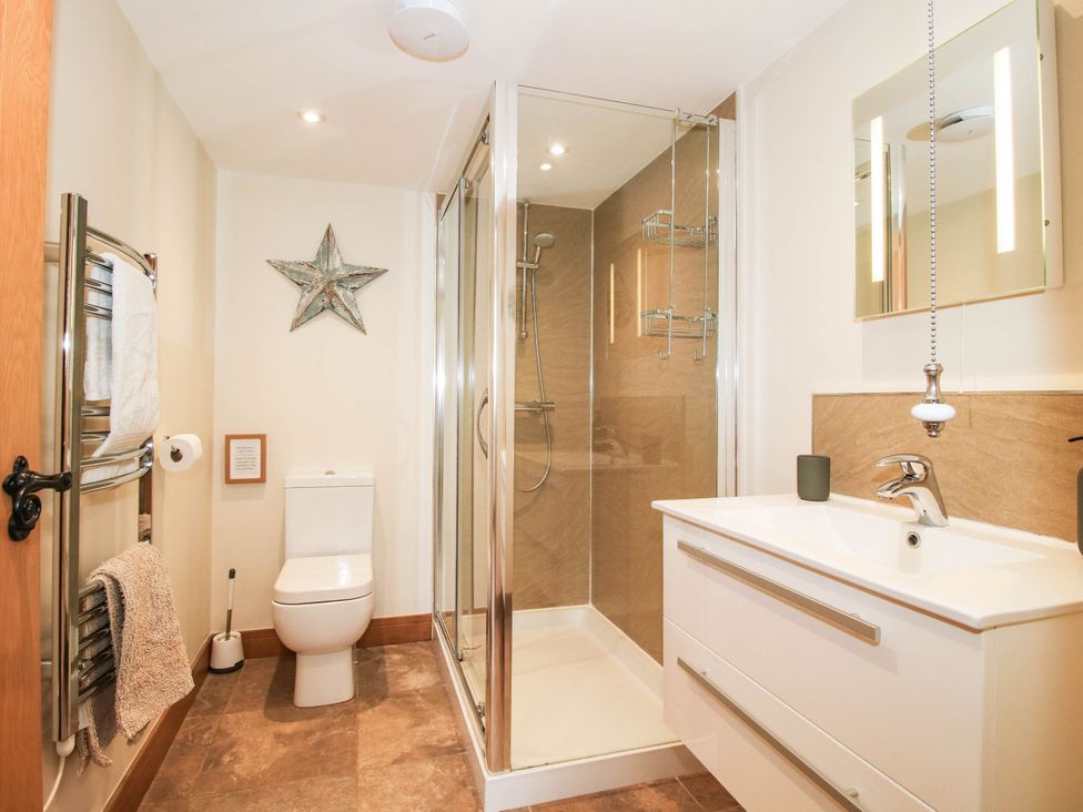 A bathroom with shower, toilet and sink at Swallows Cottage Harley near Much Wenlock