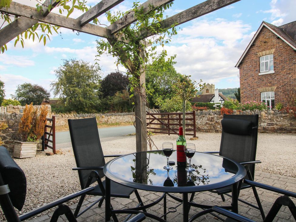 A table with chairs and drinks at Swallows Cottage in Harley near Much Wenlock