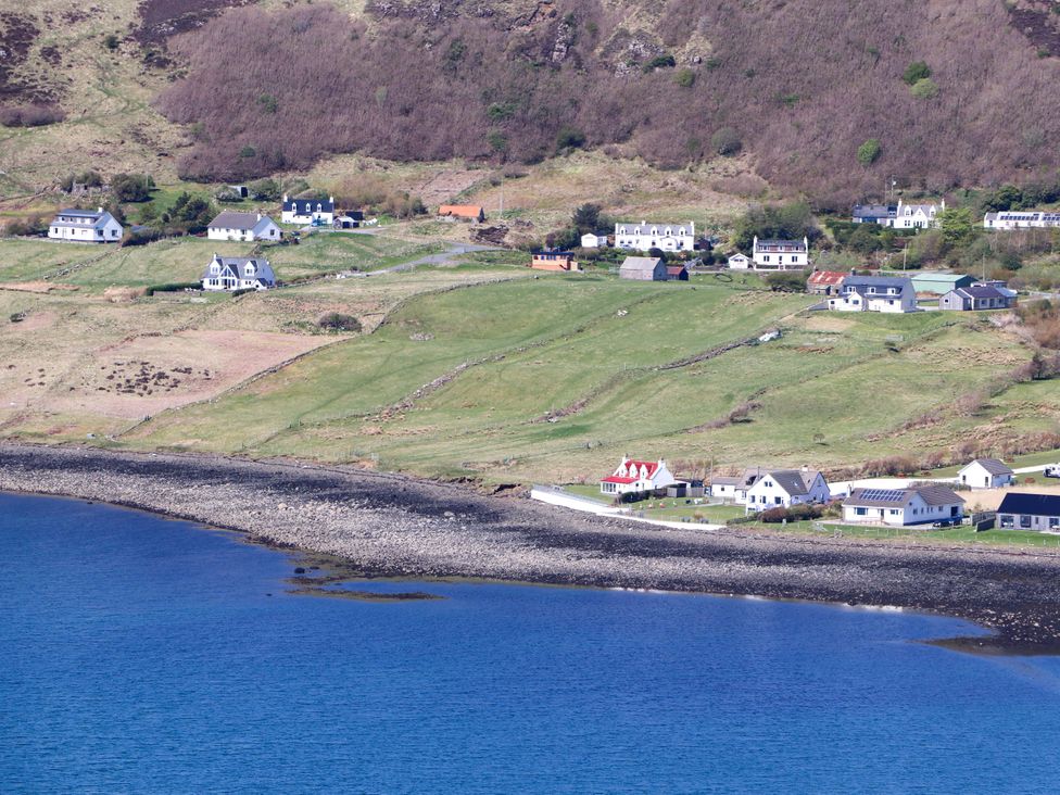 A view of houses along a shoreline at Ceól na Mara in Uig