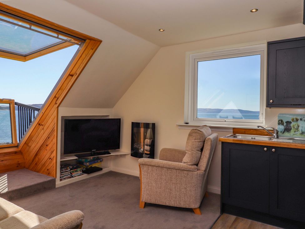 A living room with a sofa and television at Ceól na Mara in Uig