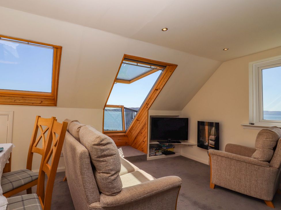 A living room with a sofa and television at Ceól na Mara in Uig