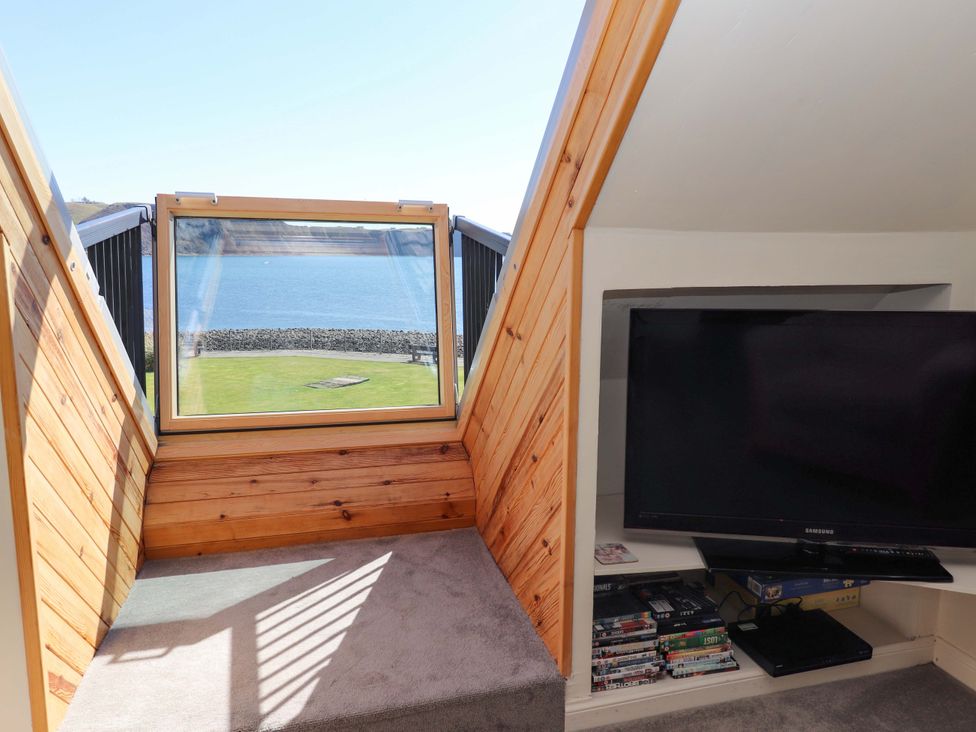 A snug with a window overlooking a garden at Ceól na Mara in Uig