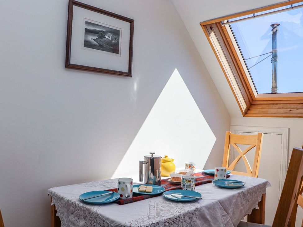 A dining room with a table set for breakfast at Ceól na Mara in Uig
