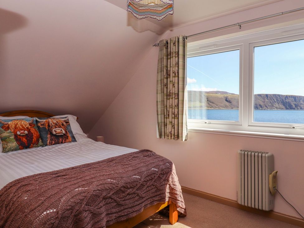 A bedroom with a bed and a window at Ceól na Mara in Uig