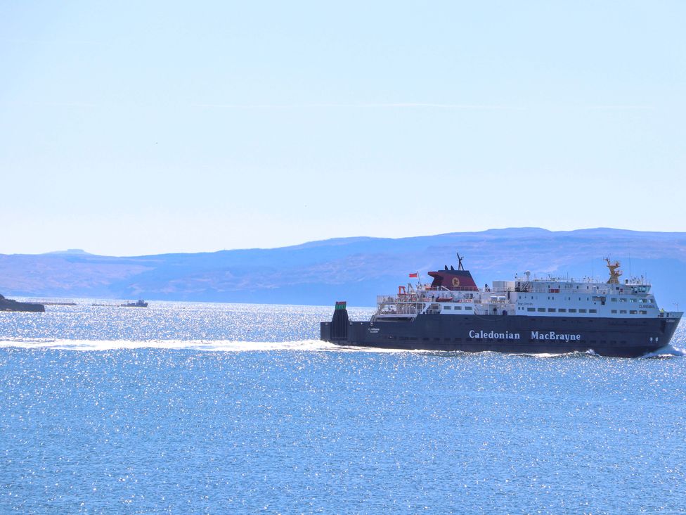 A ferry sailing on water near islands at Ceól na Mara in Uig