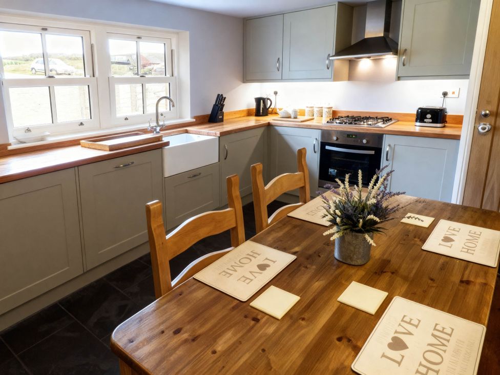 A kitchen with sink and stove at Little Owl Barn in Longnor