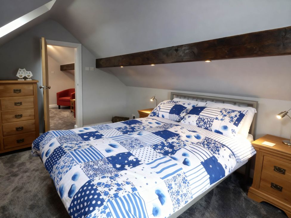 A bedroom with a bed and bedside tables at Little Owl Barn in Longnor