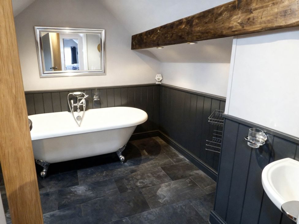 A bathroom with a bathtub and sink at Little Owl Barn, Longnor