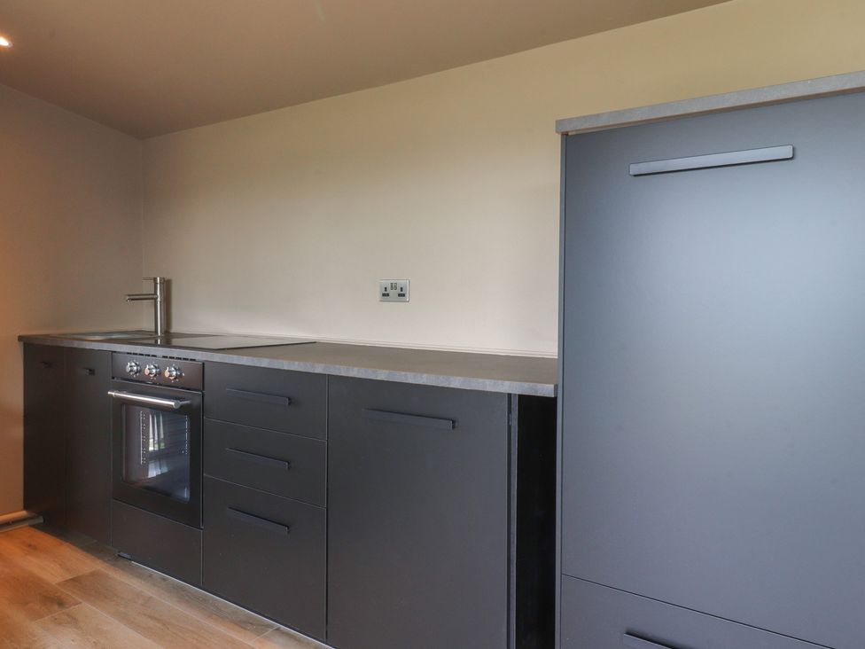 A kitchen with a sink and oven at Heath Hideaway