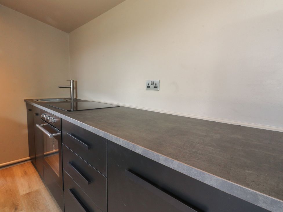 A kitchen with a sink and stove at Heath Hideaway