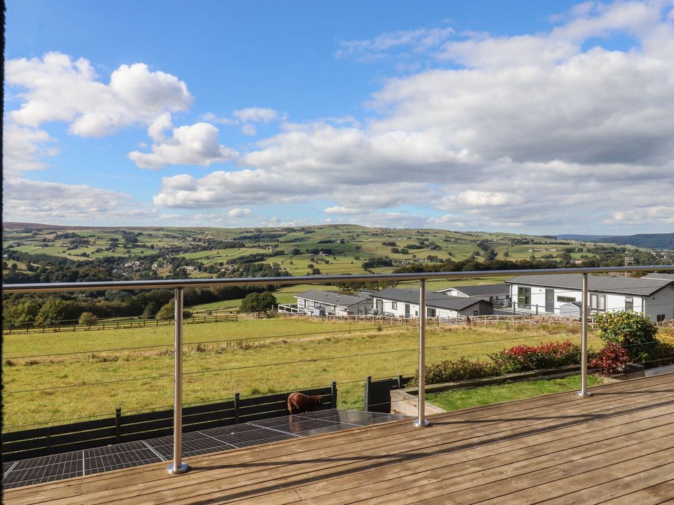 An outdoor area with a view of hills and buildings at Heath Hideaway