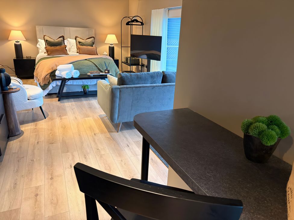 A bedroom with a bed and sofa at Heath Hideaway in Norland near Ripponden