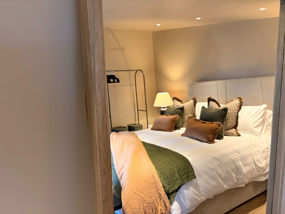 A bedroom with a bed and a lamp at Heath Hideaway Norland near Ripponden