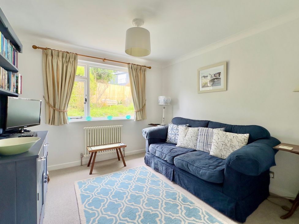 A living room with a sofa and coffee table at Kilcarreg in Rock near Wadebridge