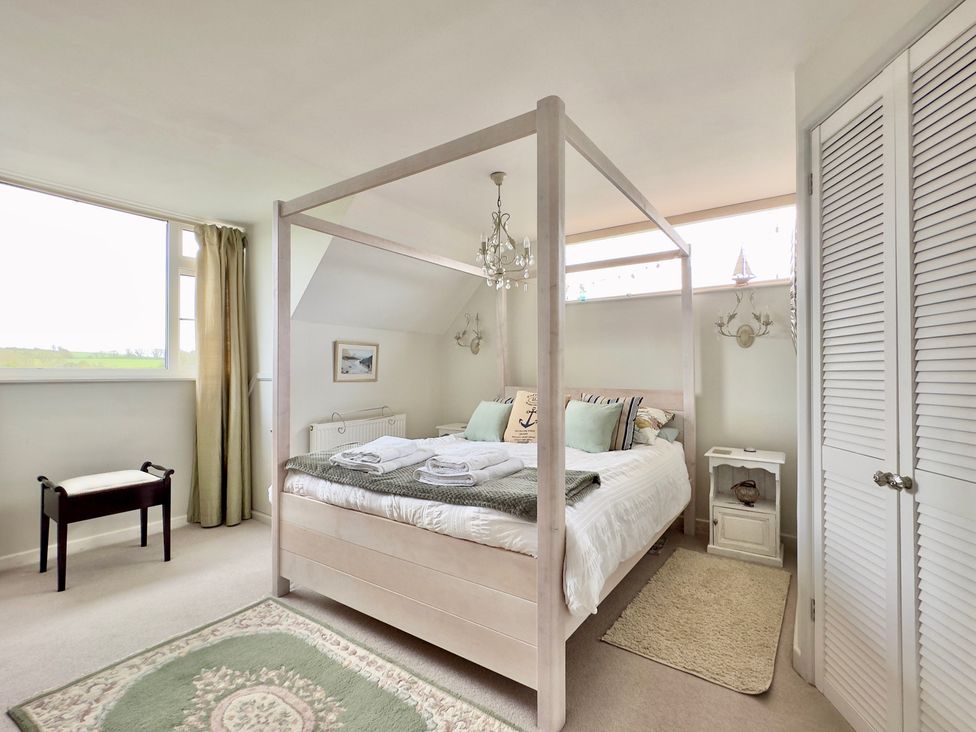 A bedroom with a four-poster bed and side tables at Kilcarreg Rock near Wadebridge