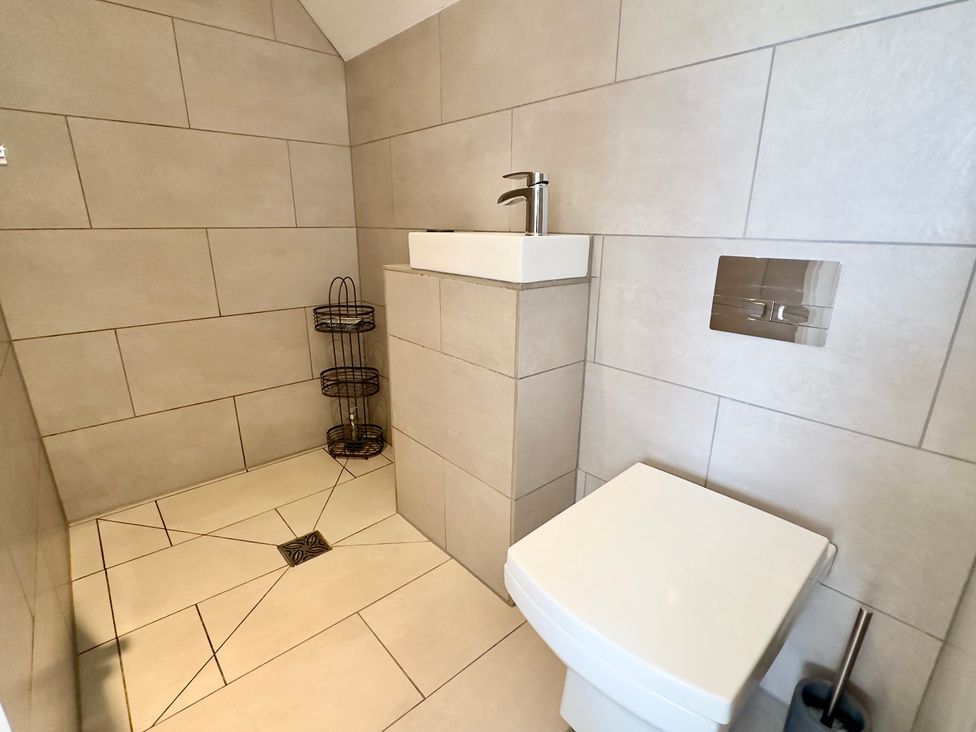 A bathroom with a toilet and sink at Kilcarreg in Rock near Wadebridge