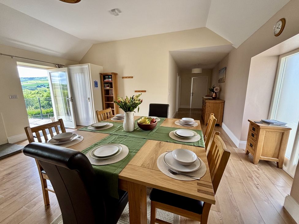 A dining room with a table set for a meal at Llaethdy - The Dairy Boncath near Crymych