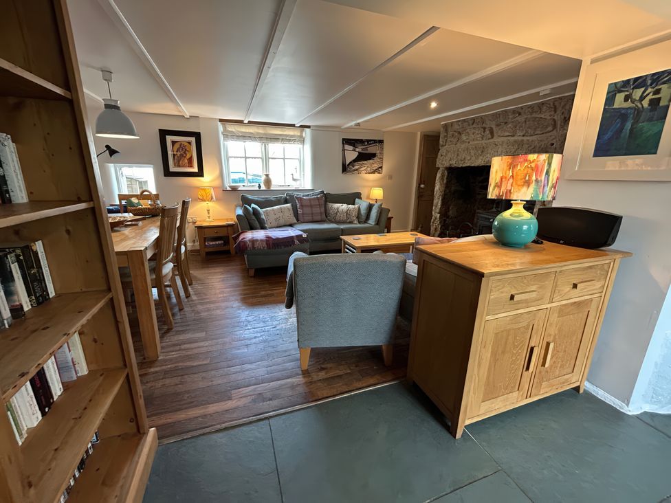A living room with a sofa and dining table at 14 Boscaswell Downs Pendeen near St Just