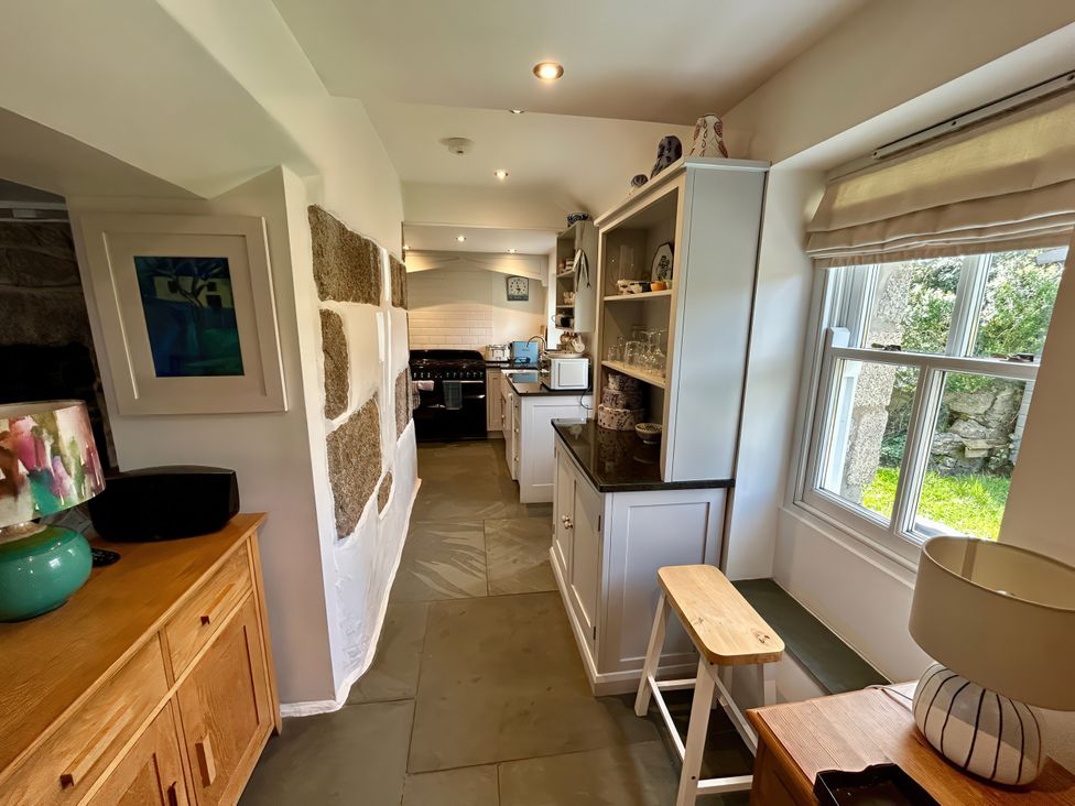 A kitchen with shelves and appliances at 14 Boscaswell Downs Pendeen near St Just