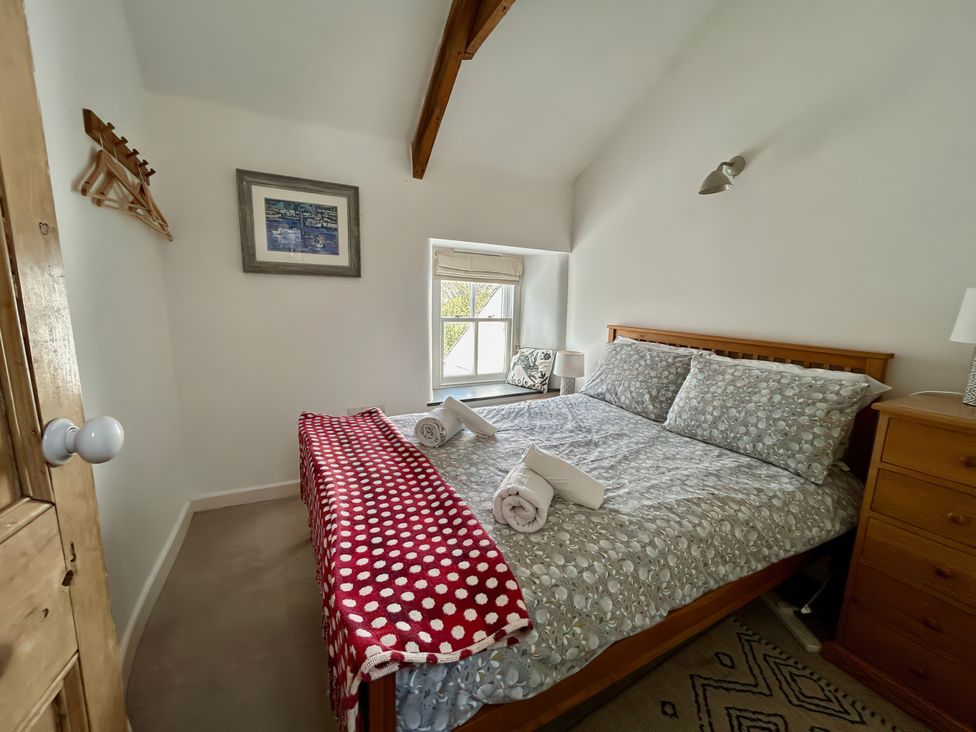 A bedroom with a bed and bedside lamps at 14 Boscaswell Downs in Pendeen near St Just