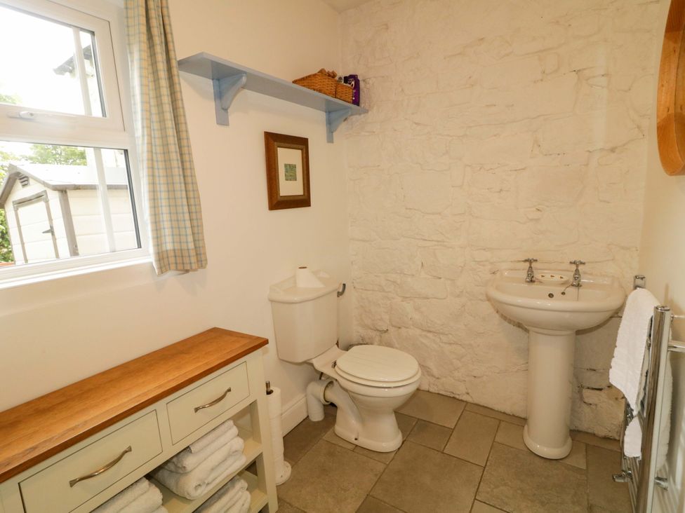 A bathroom with a toilet and sink at Rosslare Cottage in Broughshane