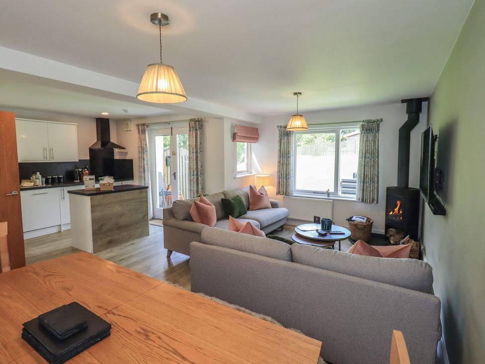 A living room with a sofa and coffee table at Yew - Woodland Cottages in Bowness-On-Windermere