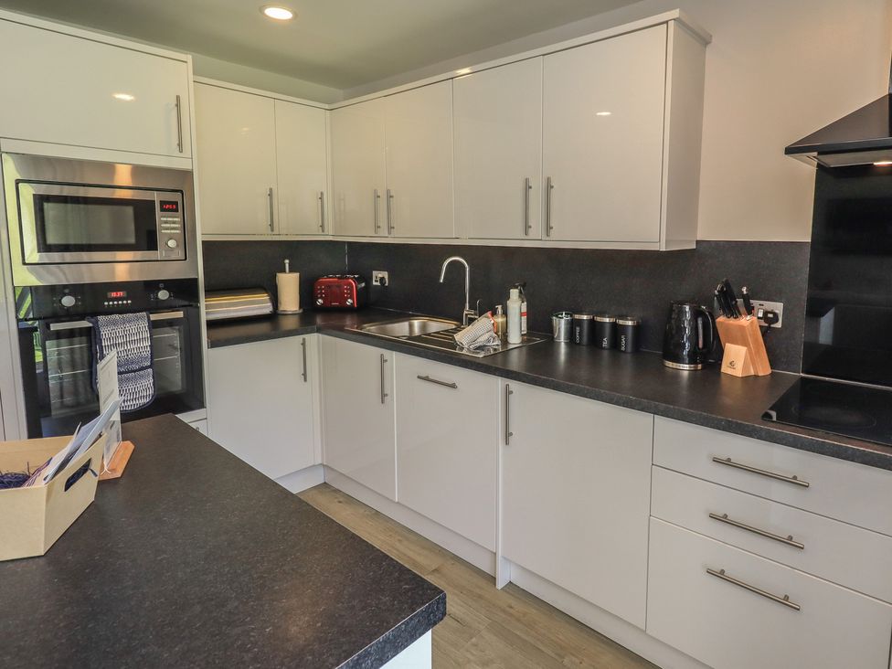 A kitchen featuring cabinets and appliances at Yew - Woodland Cottages Bowness-On-Windermere