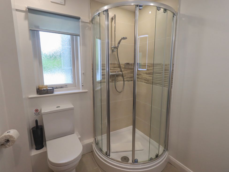 A bathroom with a shower and toilet at Yew - Woodland Cottages Bowness-On-Windermere