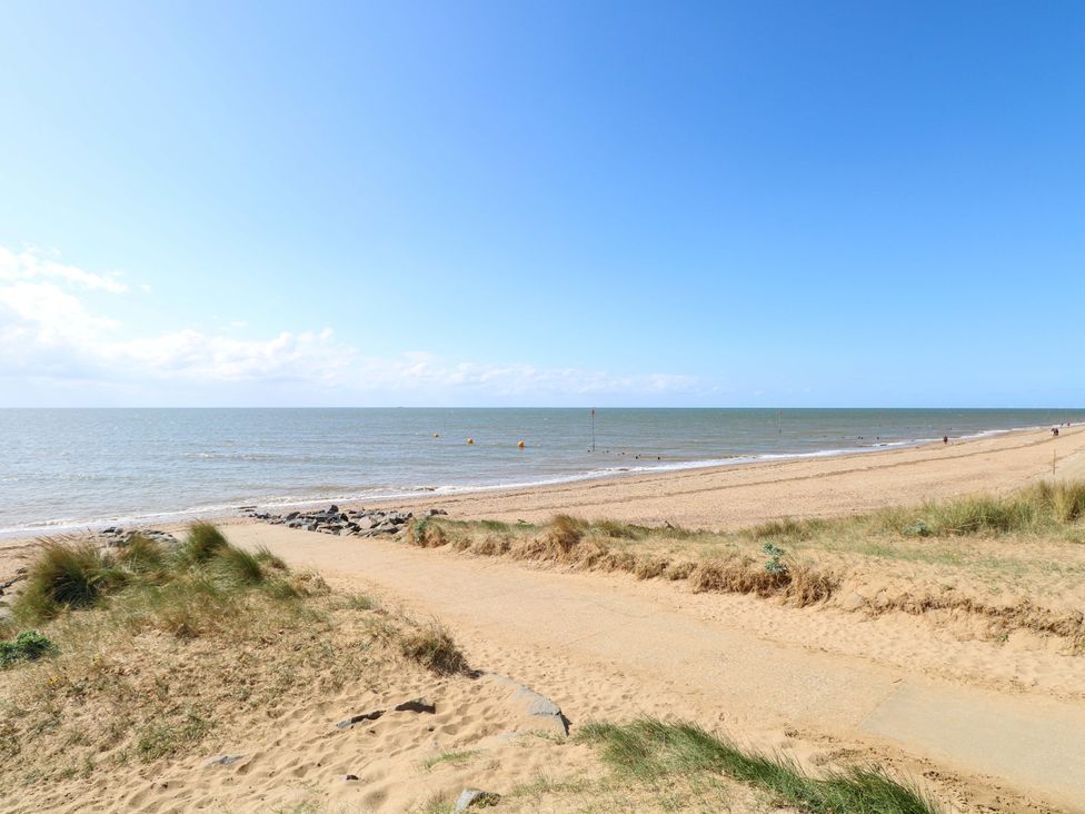 A beach with sand and sea at Fern Cottage in Heacham