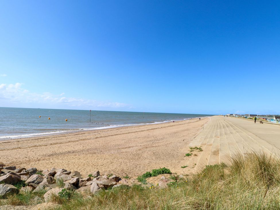 A beach with sand and sea at Fern Cottage in Heacham