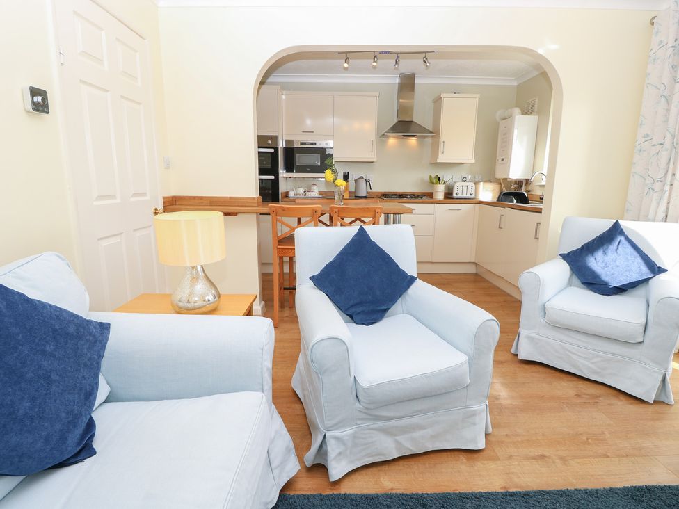 A living room with sofas and a dining table at Roebeck Retreat in Ryde