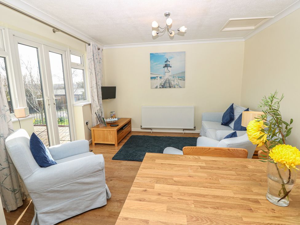 A living room with a sofa and armchair at Roebeck Retreat in Ryde