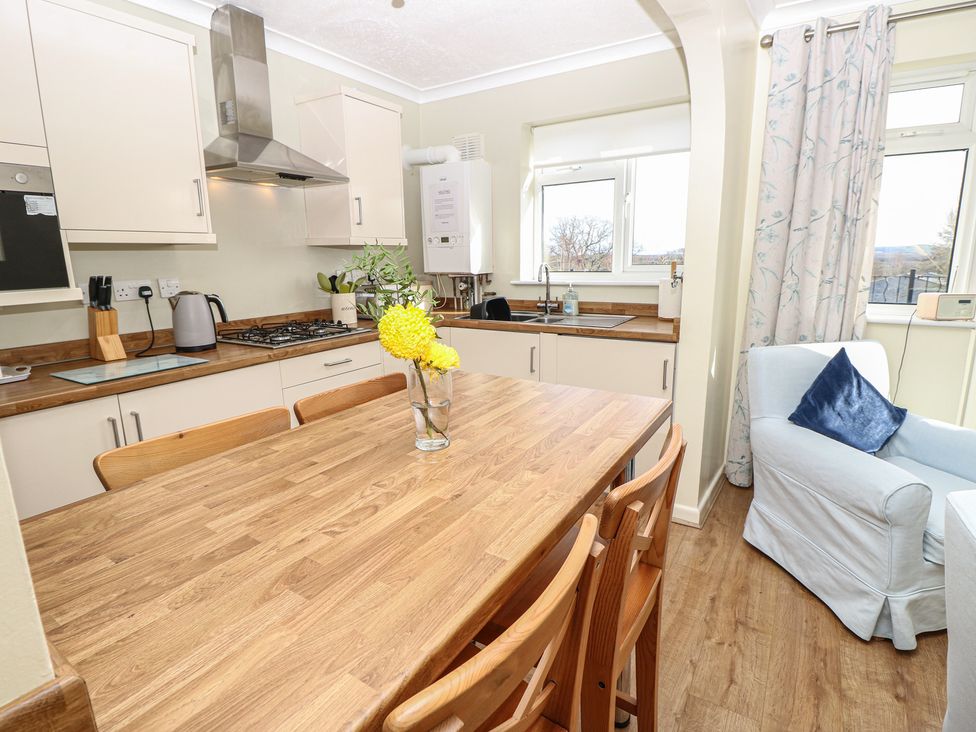 A kitchen with a dining table and chairs at Roebeck Retreat in Ryde