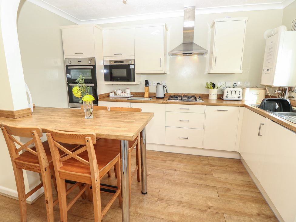 A kitchen with a table and chairs at Roebeck Retreat in Ryde