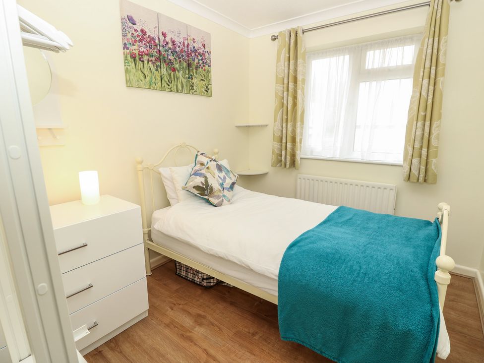 A bedroom with a bed and chest of drawers at Roebeck Retreat in Ryde