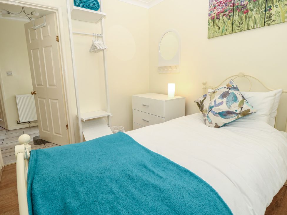 A bedroom with a bed and bedside table at Roebeck Retreat in Ryde