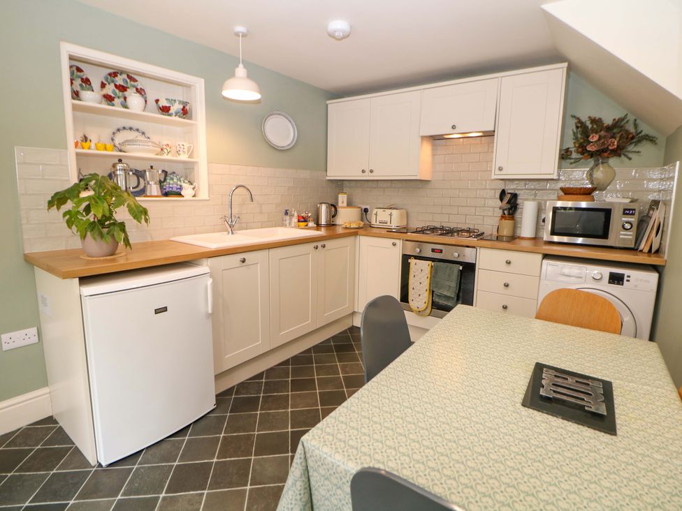 A kitchen with cabinetry and appliances at Brookside Barn in Bradwell