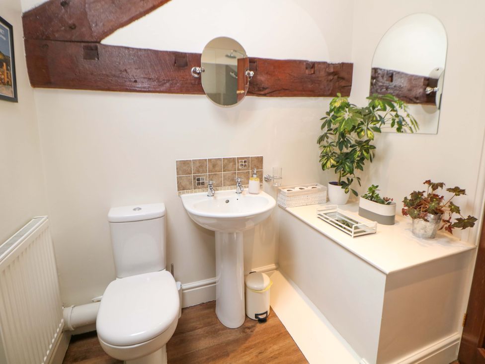 A bathroom with a sink and toilet at Brookside Barn in Bradwell