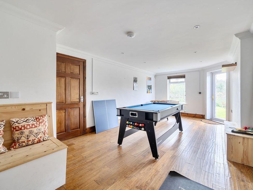 A game room with a pool table and a door leading outside at Chapel Green Studio in Polgooth near St Austell