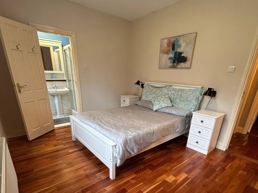 A bedroom with a bed and nightstands at The Sanctuary in Killavullen near Mallow