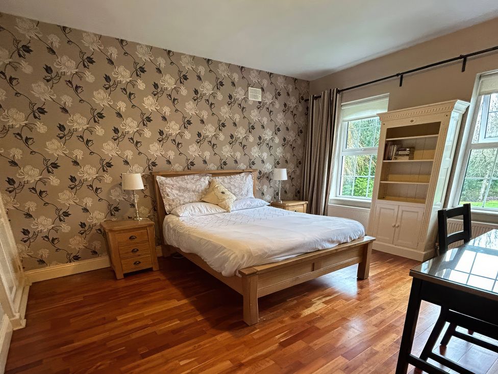 A bedroom with a bed and bookshelf at The Sanctuary in Killavullen near Mallow
