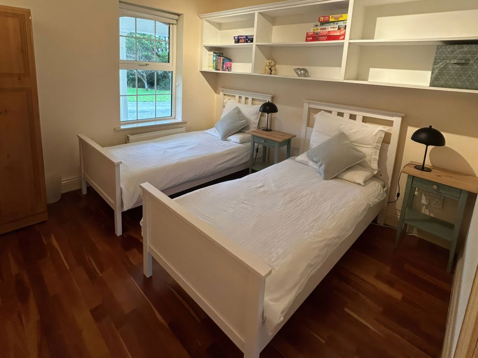 A bedroom with two beds and a window at The Sanctuary in Killavullen near Mallow