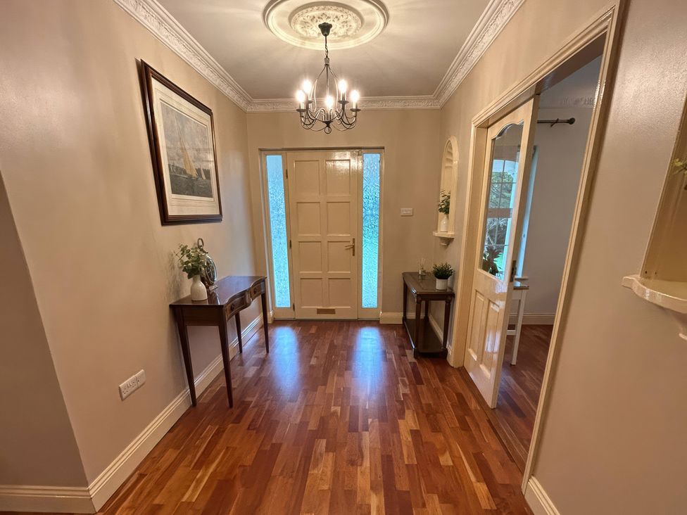 A hallway with a chandelier and a table at The Sanctuary in Killavullen near Mallow