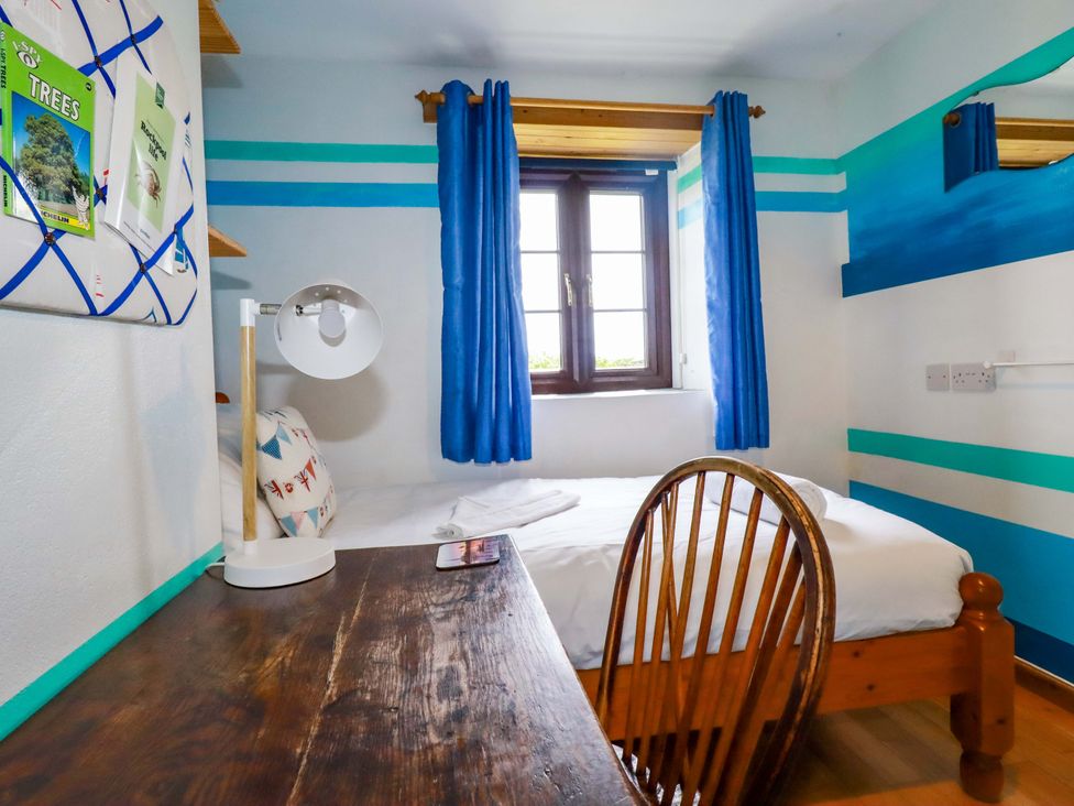 A bedroom with a bed and desk at 4 Mowhay Cottages Gorran Haven