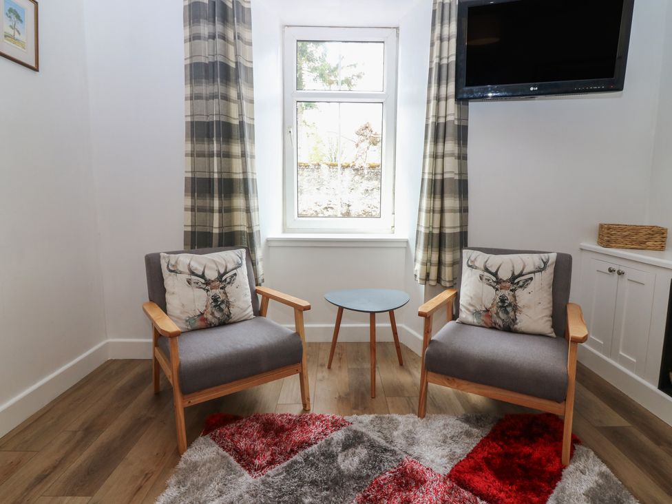 A sitting room with two chairs and a table at Alt na Voir in Tomintoul