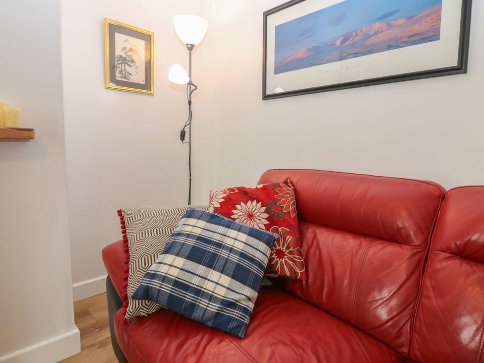 A sofa with cushions and a lamp in the living room at Alt na Voir Tomintoul