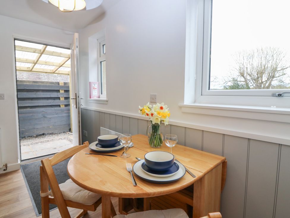 A dining area with a table and chairs at Alt na Voir in Tomintoul