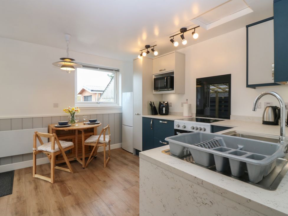 A kitchen with a dining table and chairs at Alt na Voir in Tomintoul