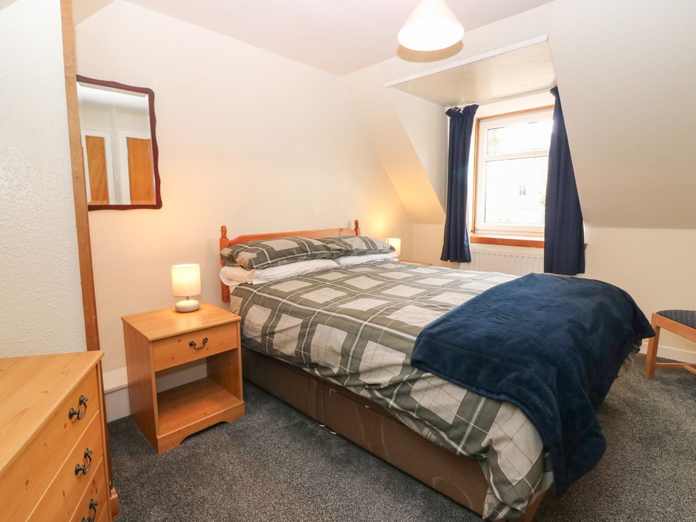A bedroom with a bed and bedside table at Alt na Voir in Tomintoul