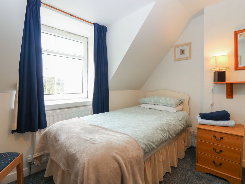 A bedroom with a bed and nightstand at Alt na Voir in Tomintoul